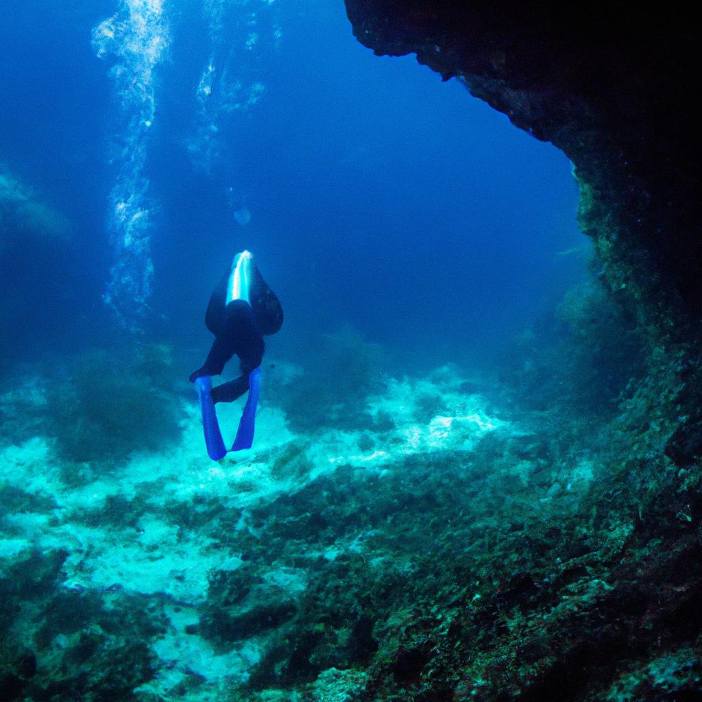 A scuba diver descending into the dark depths of The Blue Hole, Belize