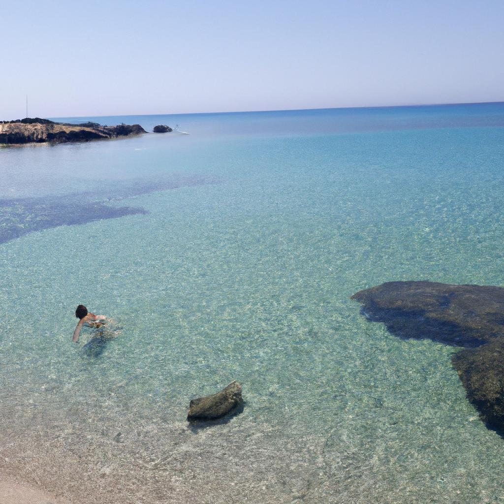 Refreshing dip in the crystal-clear waters of Arutas Beach