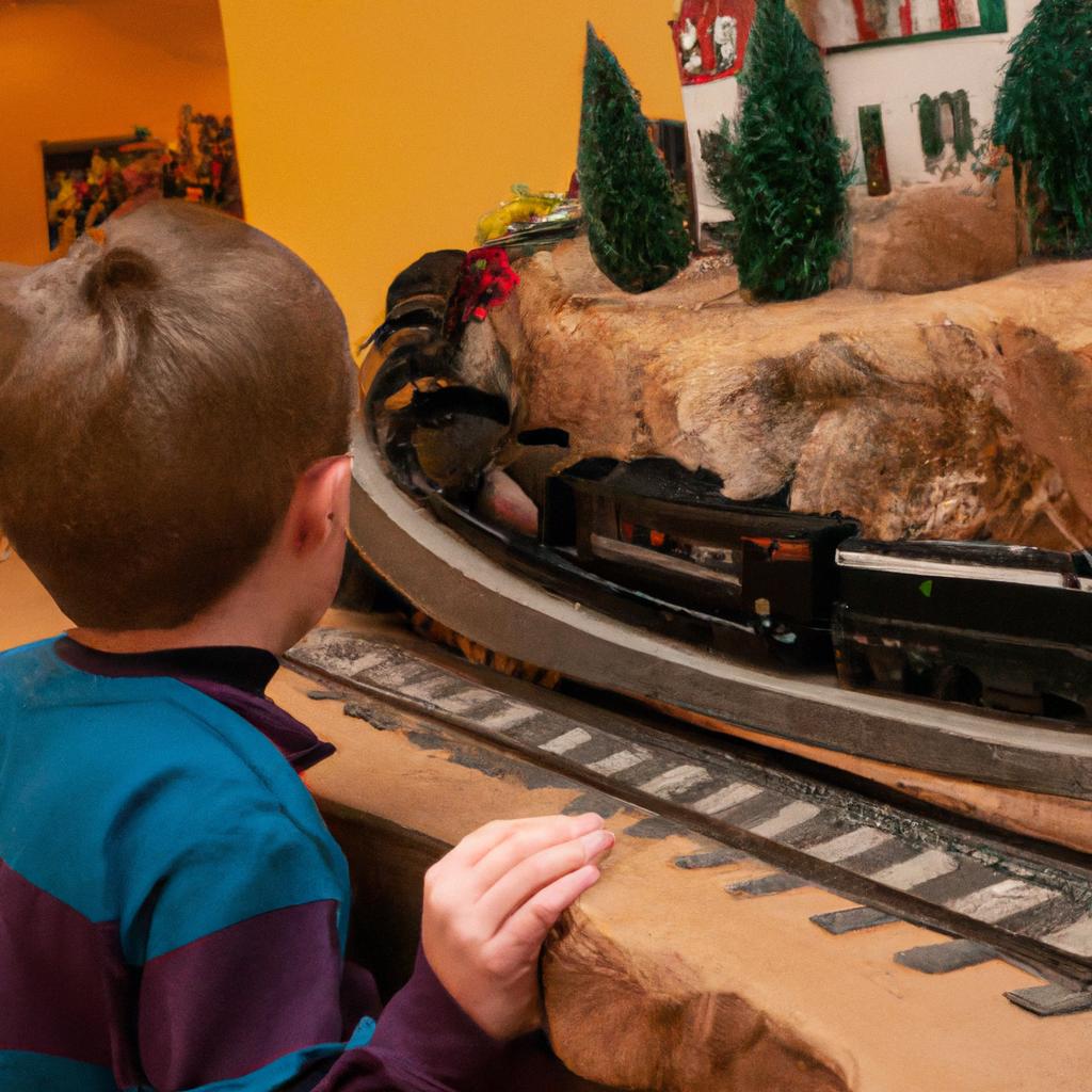 A young child captivated by a train model at the NYC train show.