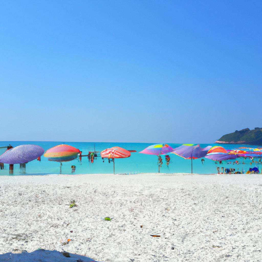 Soak up the sun under colorful umbrellas and take a dip in the crystal-clear waters of this stunning white sand beach