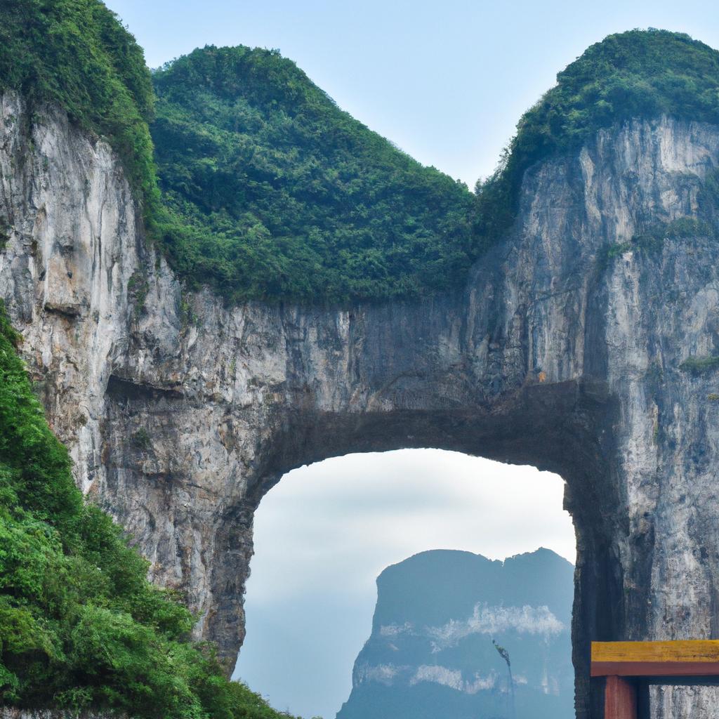 The entrance of Tianmen Cave with a natural rock arch above it.