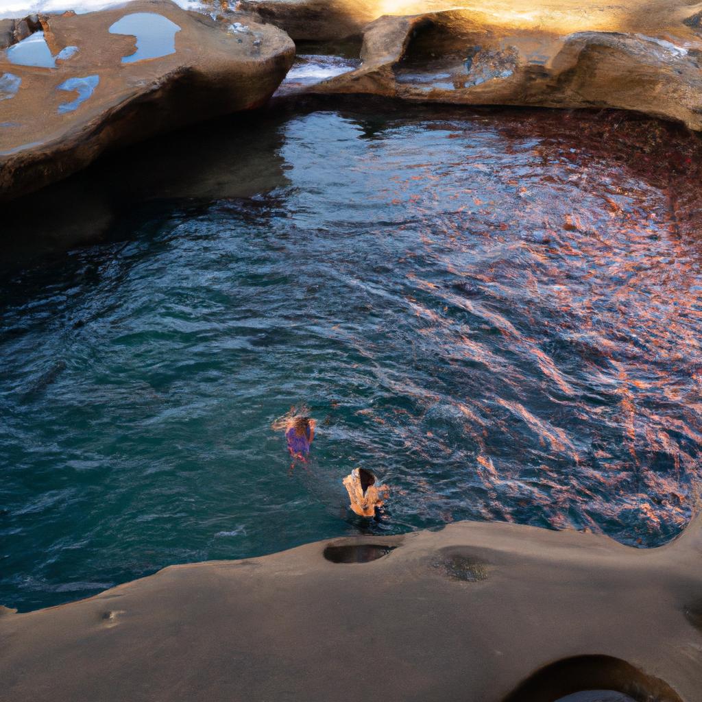 Tourists take a refreshing dip in the Figure 8 Pools to cool off from the Australian heat while enjoying the natural beauty of the pools.