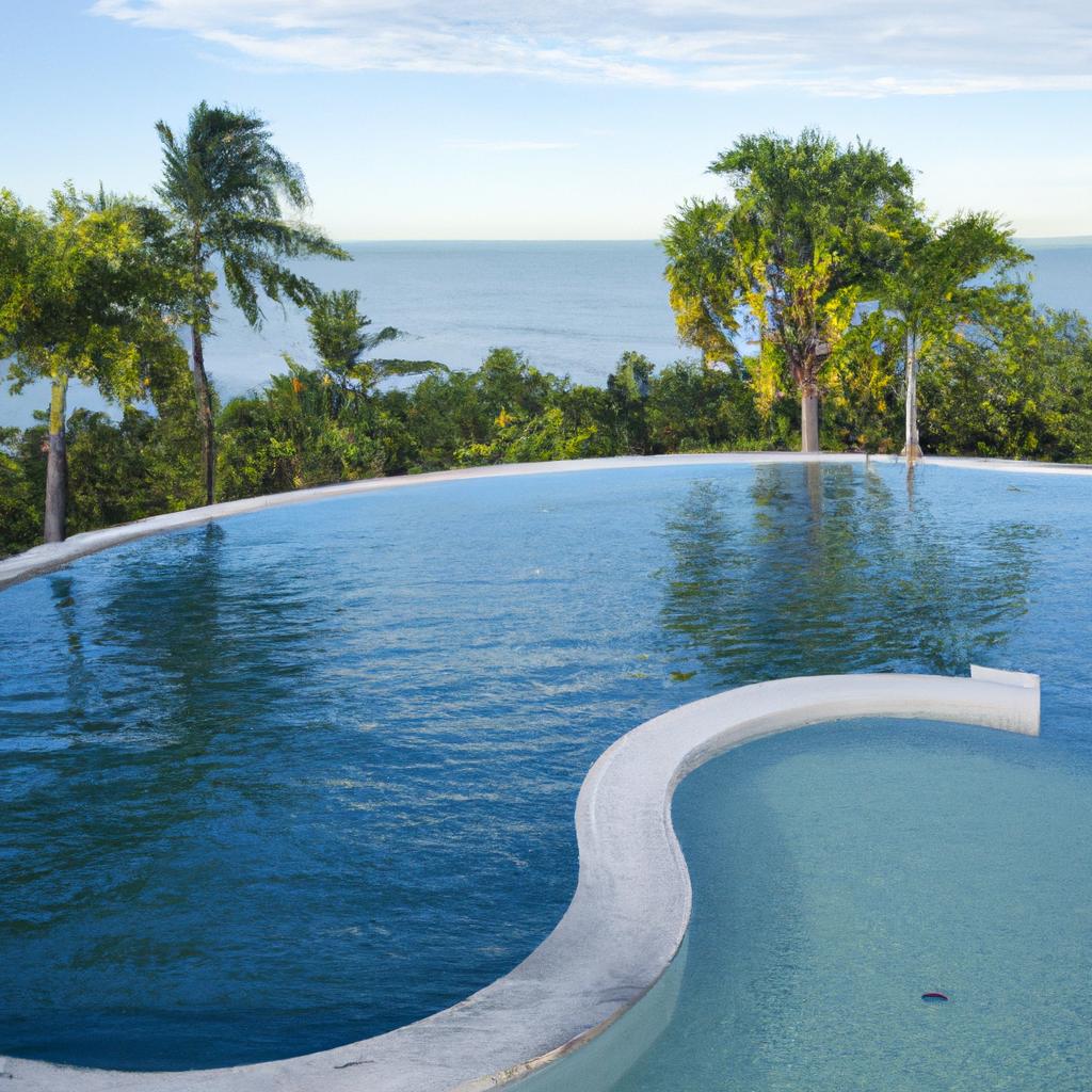 A peaceful oasis of a figure 8 swimming pool with a panoramic ocean view.