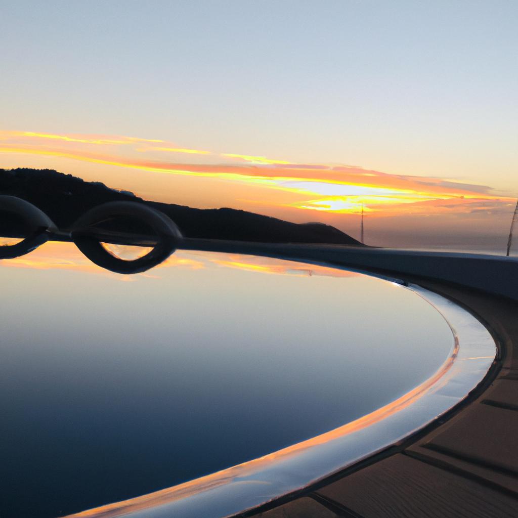 A captivating sunset view of a figure 8 swimming pool with a vanishing edge.