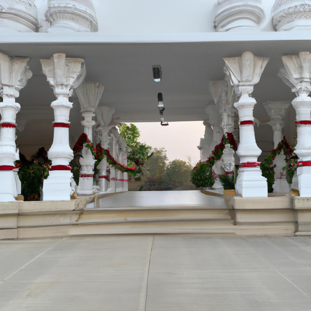 The grand entrance of the temple with its white pillars exudes a sense of majesty and grandeur.