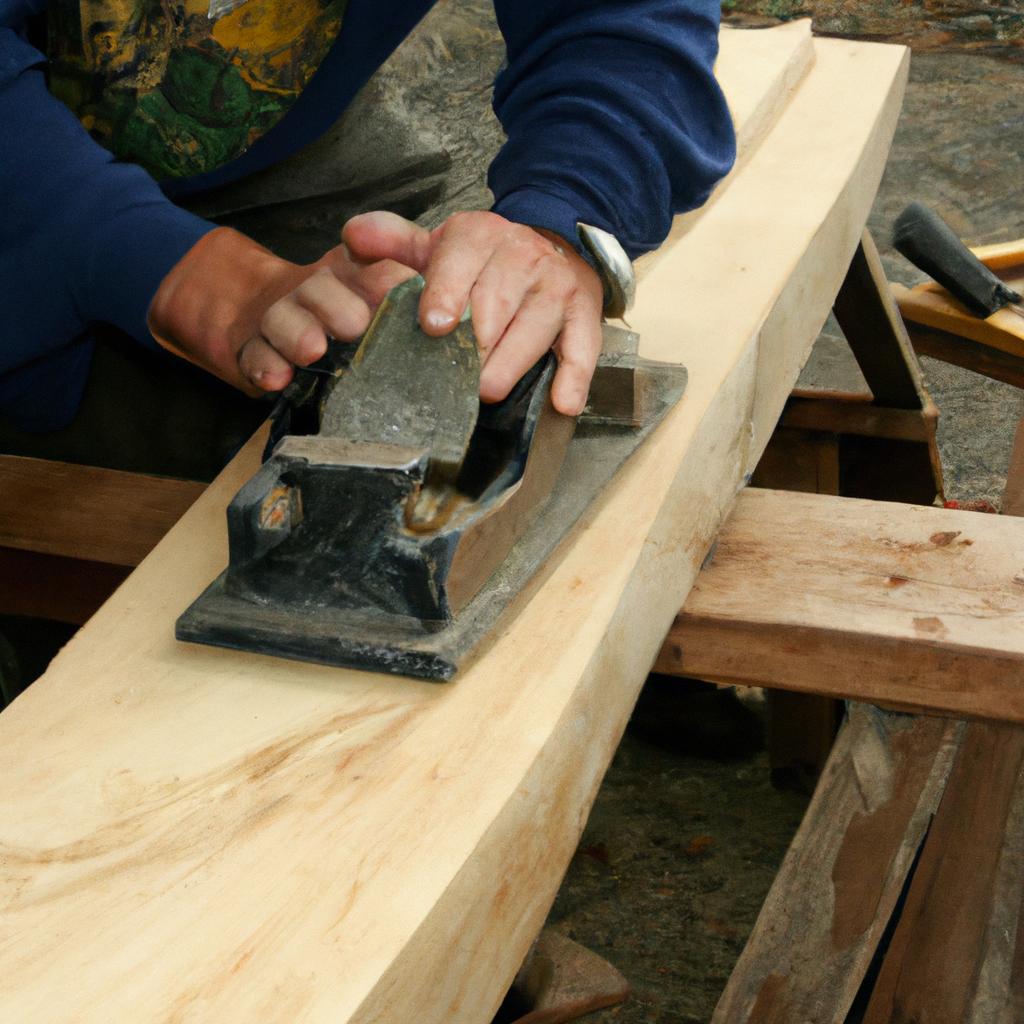 Craftsman using a hand plane to smooth out a wooden board for a hand-built bridge deck.