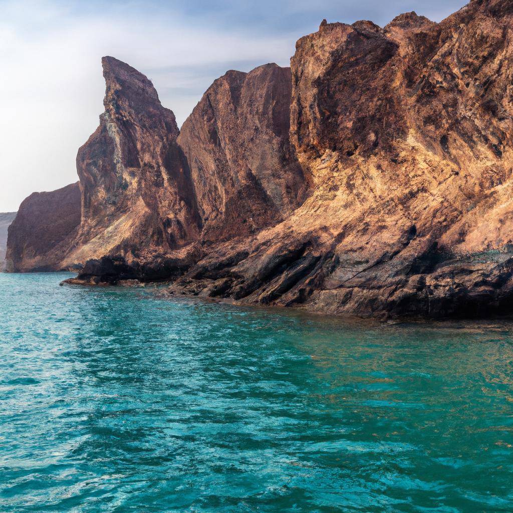 The striking cliffs of Hormuz Island create a dramatic contrast against the blue-green waters.