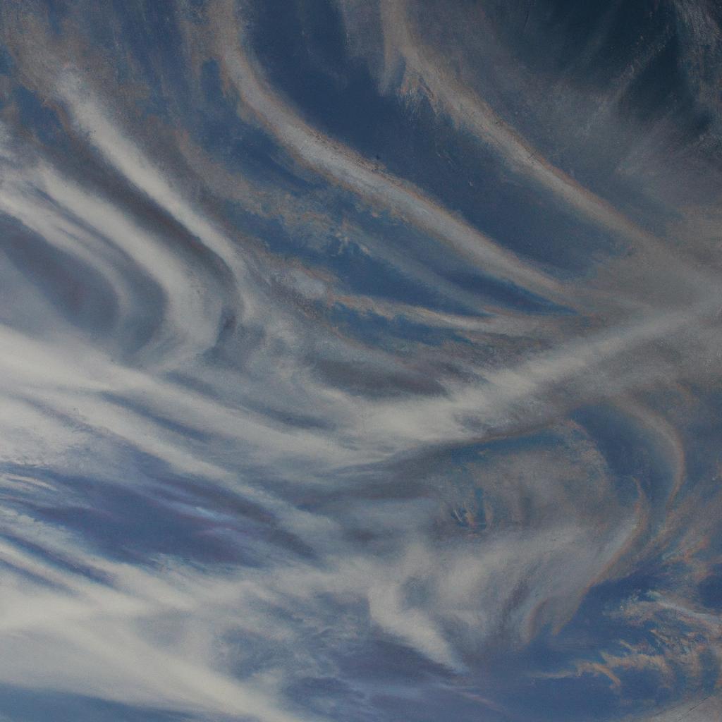 The thin, wispy strands of cirrus clouds are a beautiful sight against the blue sky.