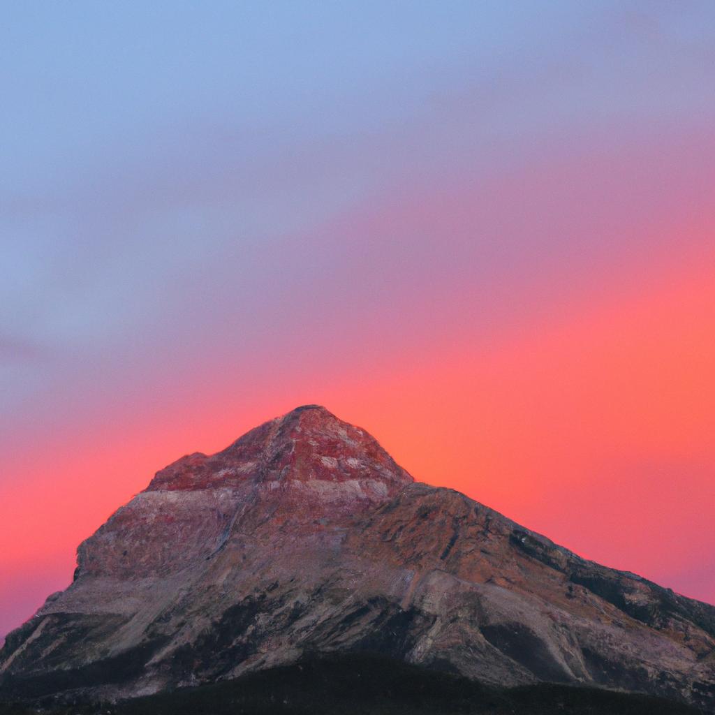 The stunning sunset over the colorful mountain peak is a sight to behold.