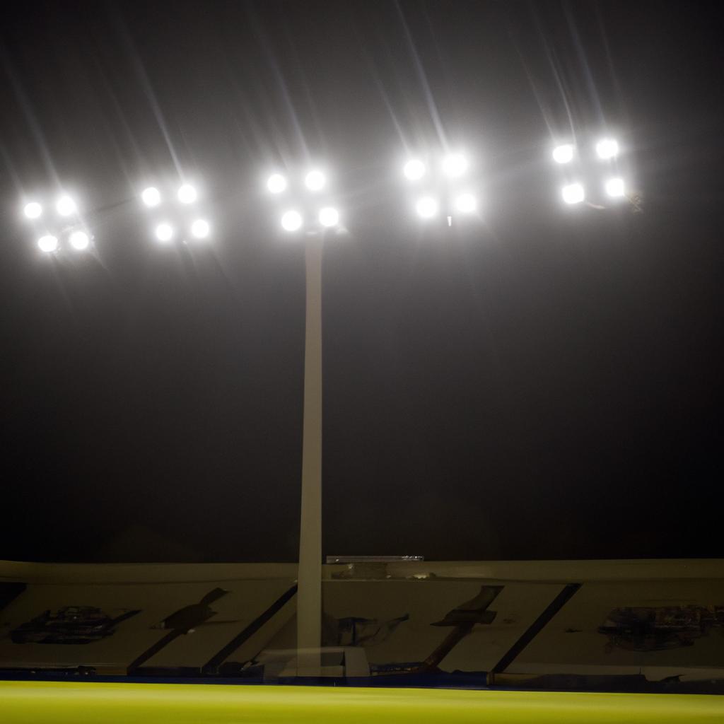 The lights of the stadium illuminate the night sky, creating a beautiful and awe-inspiring scene.