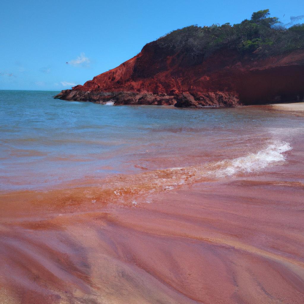 The contrast between the red sand and the crystal-clear waters is breathtaking.