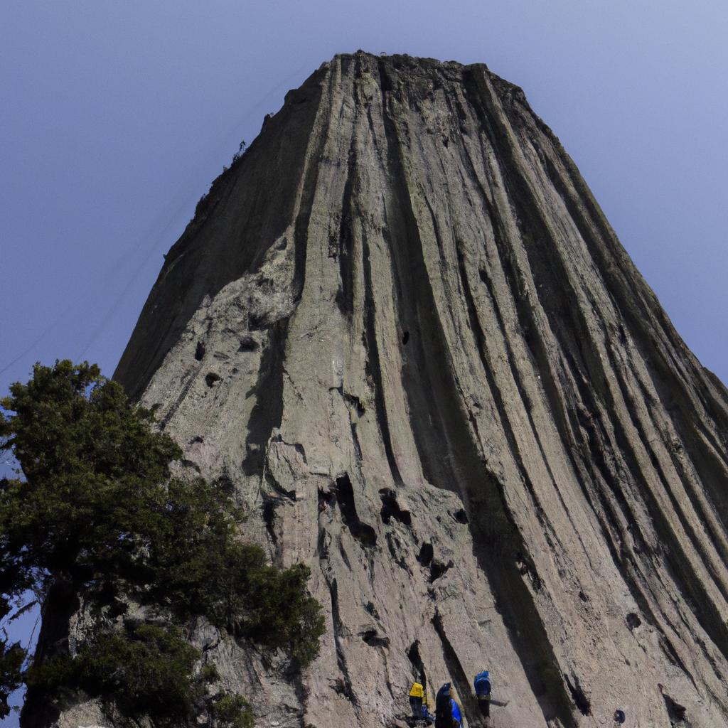 Adventurous rock climbers scaling the unique rock formation of Devils Tower Mountain