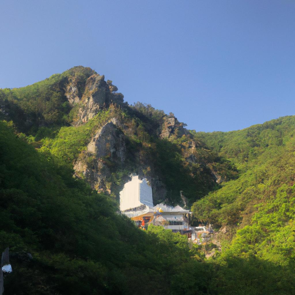 The white temple nestled among the mountains is a beacon of peace and spirituality.